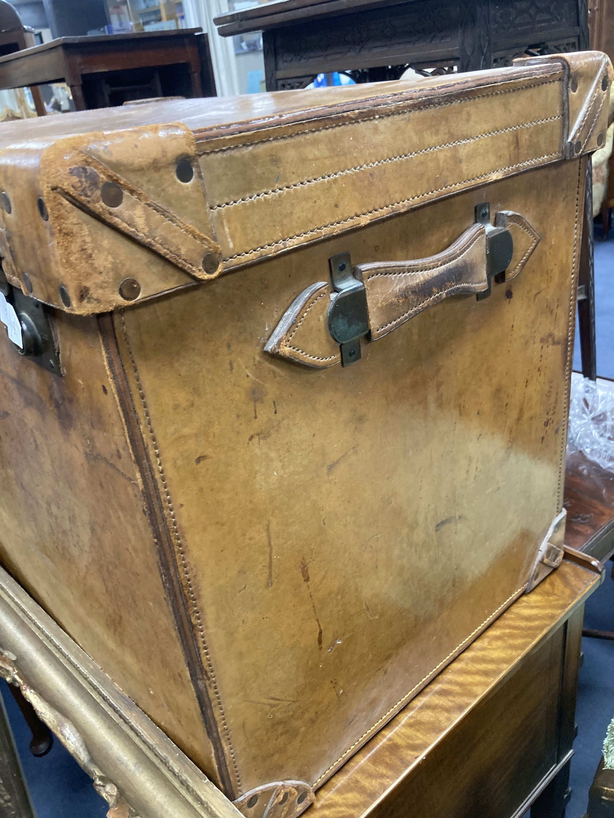 A large Victorian tan leather travelling trunk, width 76cm, depth 52cm, height 58cm together with a rectangular gilt gesso picture fram